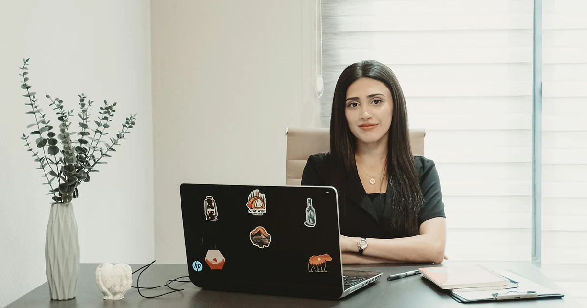 Expert sénior accompagnant un commercial en séance individuelle de vente devant un CRM, bureau moderne avec éclairage bleu et violet